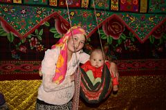 08 Yilik Headman Daughter And Her Child In A Swing In Their Sleeping Area On The Way To K2 China Trek.jpg
